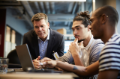 Diverse group working and sharing a laptop
