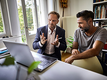 Two men viewing LPL clientworks application on computer