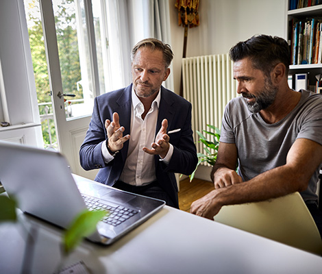 Two men viewing LPL clientworks application on computer